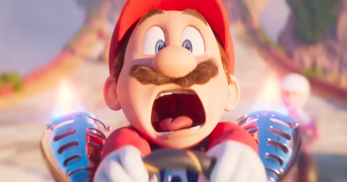 An image from The Super Mario Bros. Movie showing a close-up of Mario's screaming face as he karts around a looping racetrack.