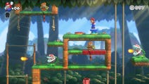 Mario vs Donkey Kong image showing Mario on a grassy platform in a jungle level