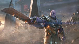 Thanos is stood wearing a suit of armour, a large double ended blade pointed away from him, his army in the background in Avengers: Endgame.