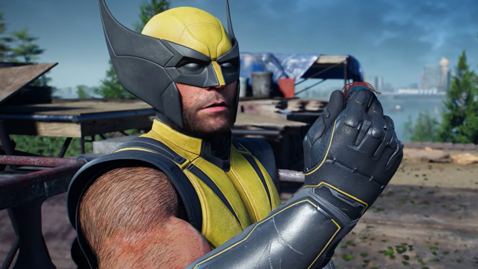Marvel's Wolverine screenshot showing the titular antihero in his yellow costume looking at something small in his hand.