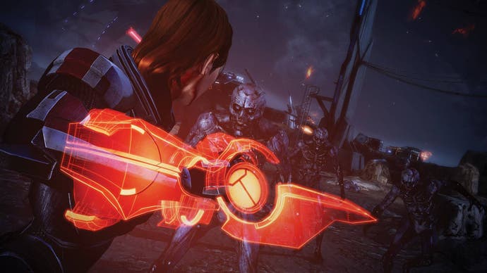 Female Commander Shepard preparing to stab a zombie-like enemy with a red energy sword.