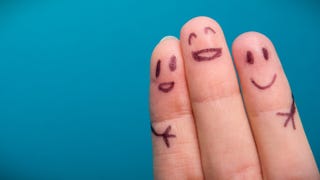 A photograph of three fingers, as seen from their inside/underneath side, with little smiling faces biro-d onto them. The two outside fingers also have little stick arms drawn onto them, as if the blissfully happy face in the middle is hugging them. Lovely!