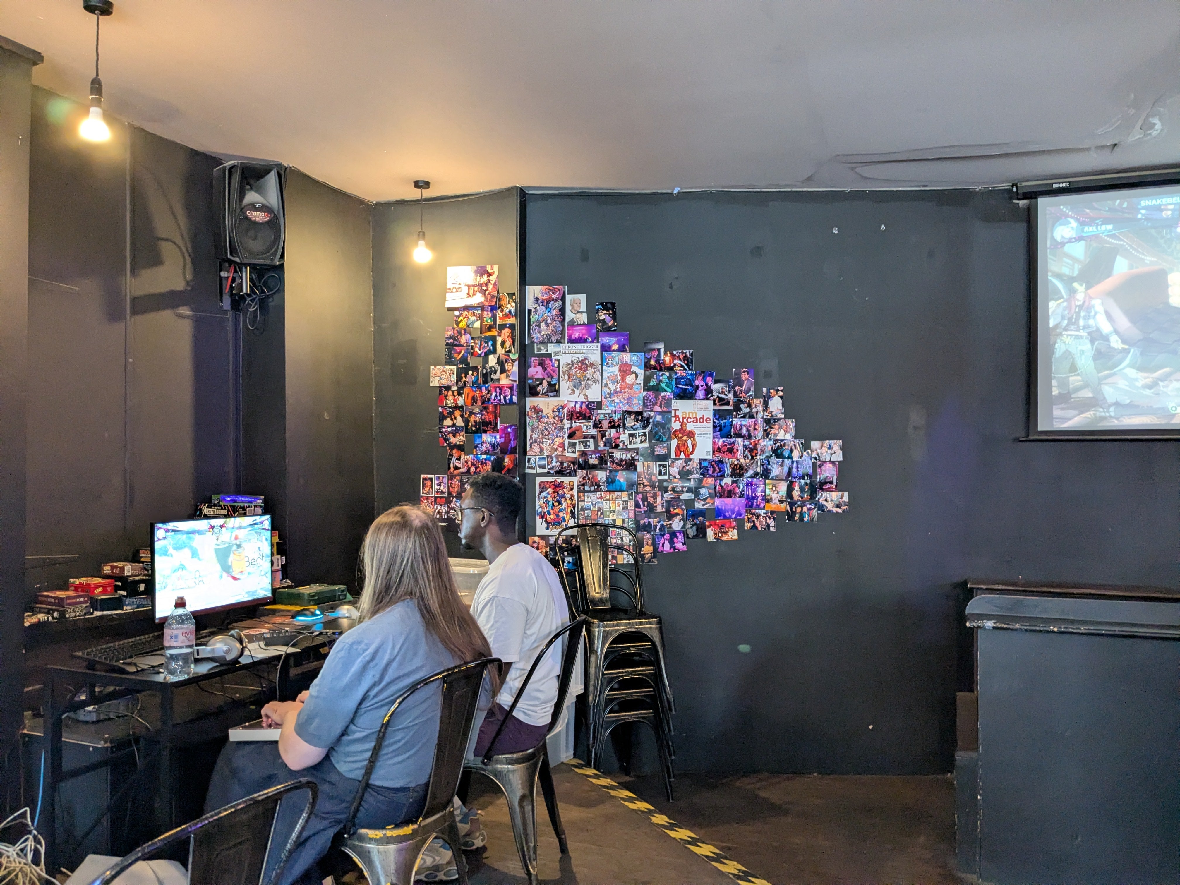Wall of photos at Meltdown London Esports bar.