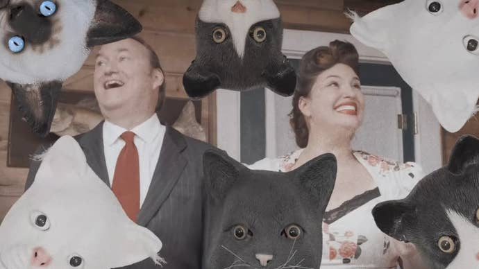 A smiling, happy, ’60s-esque couple are smiling surrounded by people wearing slightly realistic cat masks in a trailer for Mewgenics.
