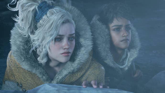 A woman and boy crouch behind rocks in thick fur coats in Monster Hunter Wilds.