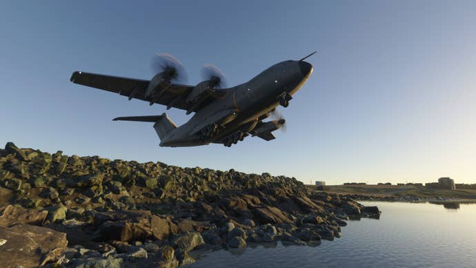A huge aircraft takes off next to a lake.