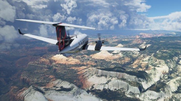A light aircraft flying above a mountain range.