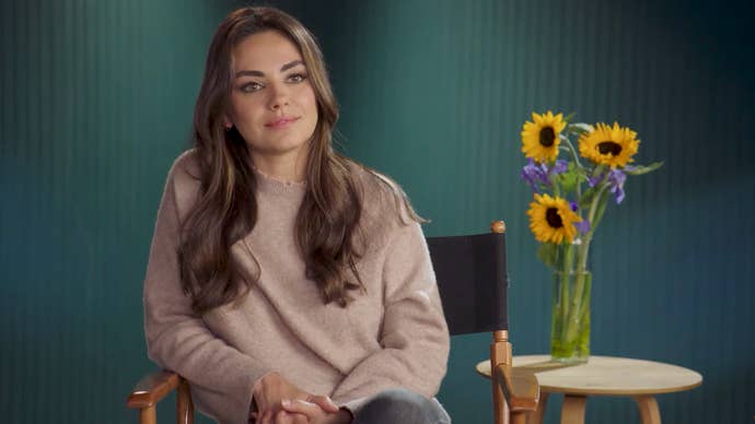 Mila Kunis sits next to a vase of sunflowers in the announcement video for World of Warcraft’s Pet Pack for Ukraine charity bundle