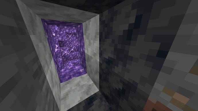 A Minecraft screenshot of an Amethyst Geode's layers: an outer layer of Smoothed Basalt (black), then a middle layer of Calcite (white), and finally the Amethyst centre (purple).