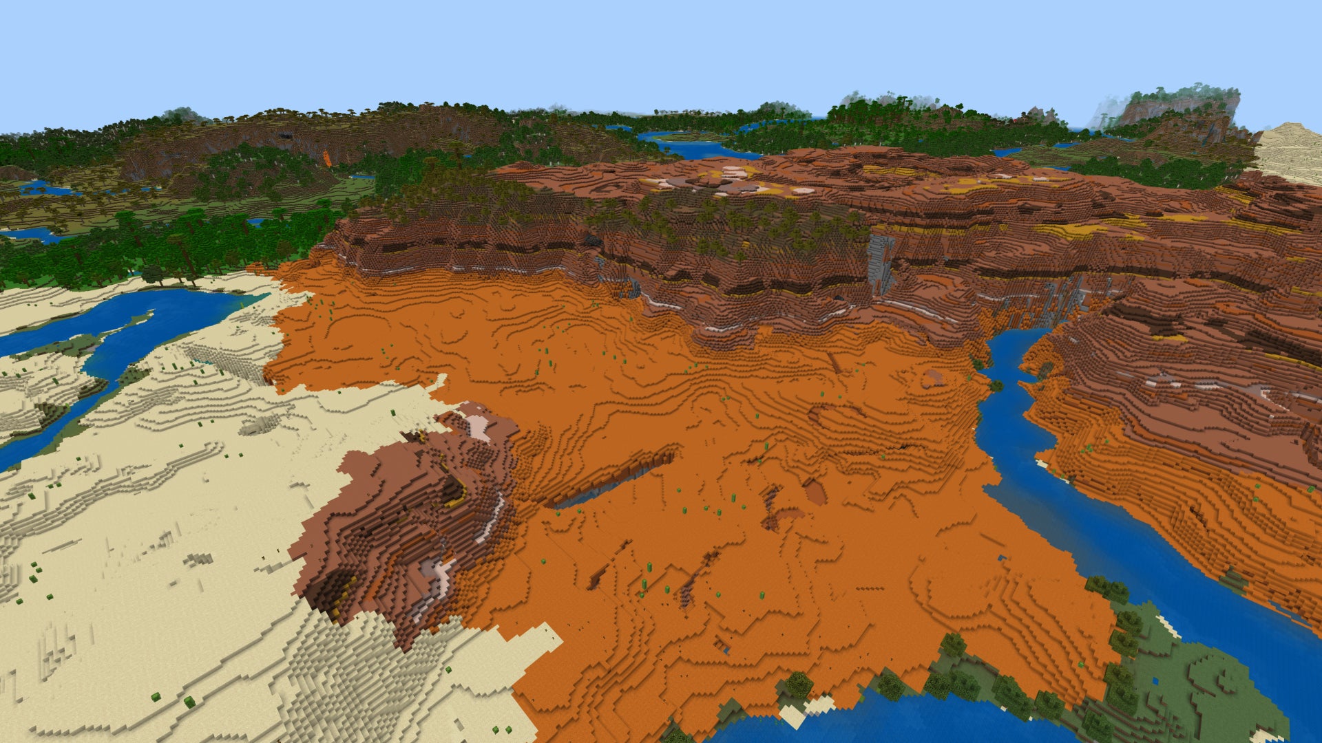 Screenshot of a top-down view of a Badlands biome in Minecraft Bedrock, with the entrance to a ravine in the foreground below. - 11