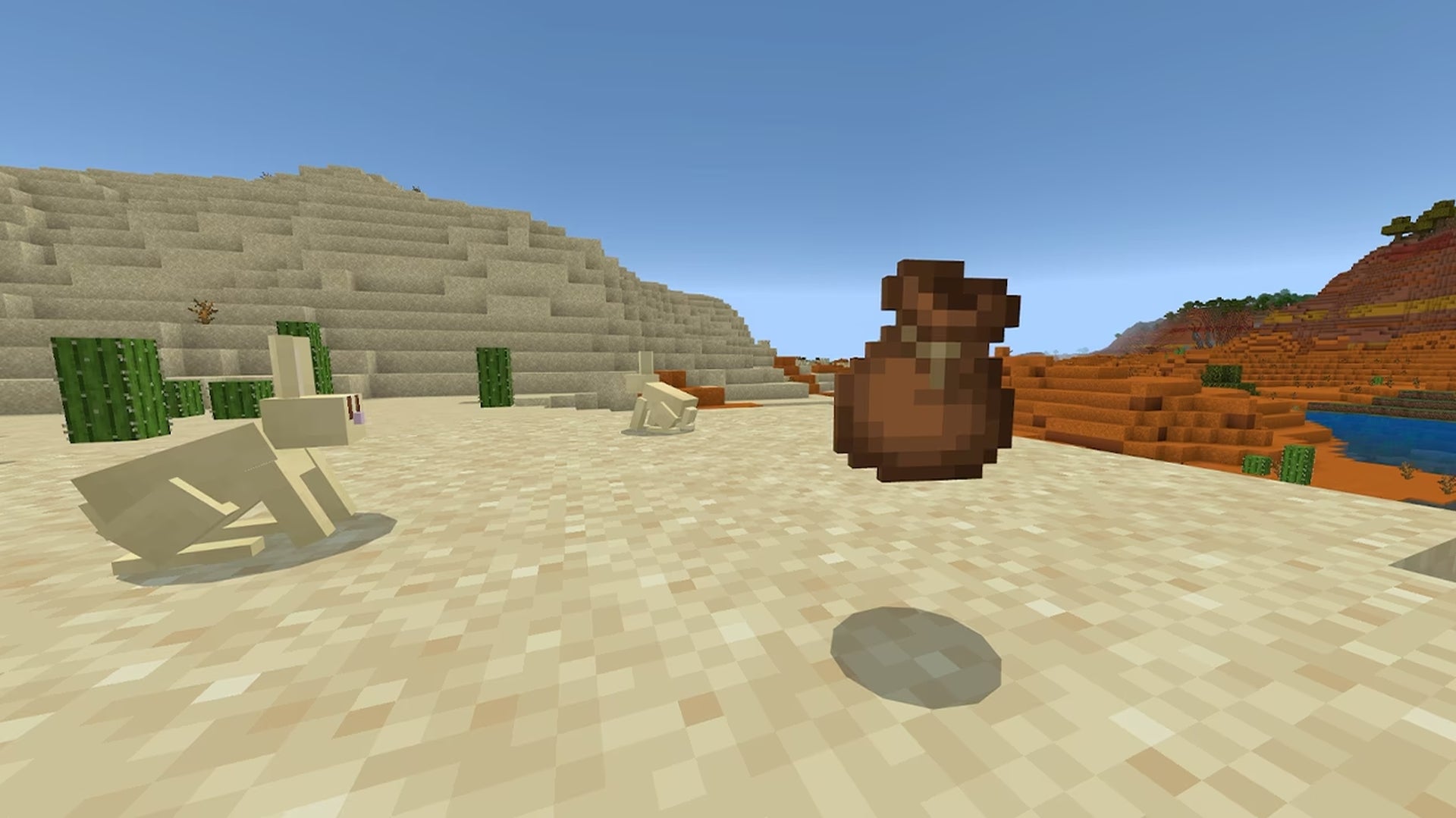 A bundle in Minecraft, in the desert, looked upon by a rabbit. - 1