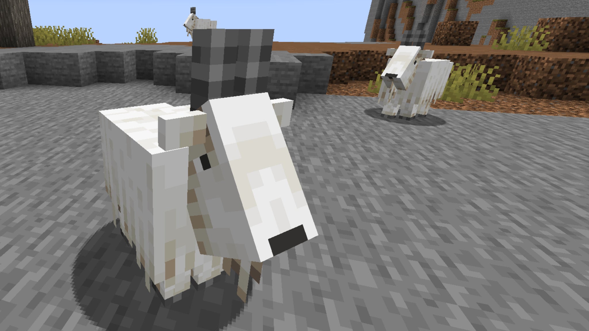 A Minecraft screenshot of three Goats at varying distances from the player. - 5