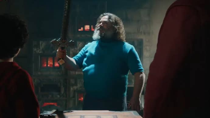 Jack Black as Steve in the Minecraft movie, he’s holding up a sword.