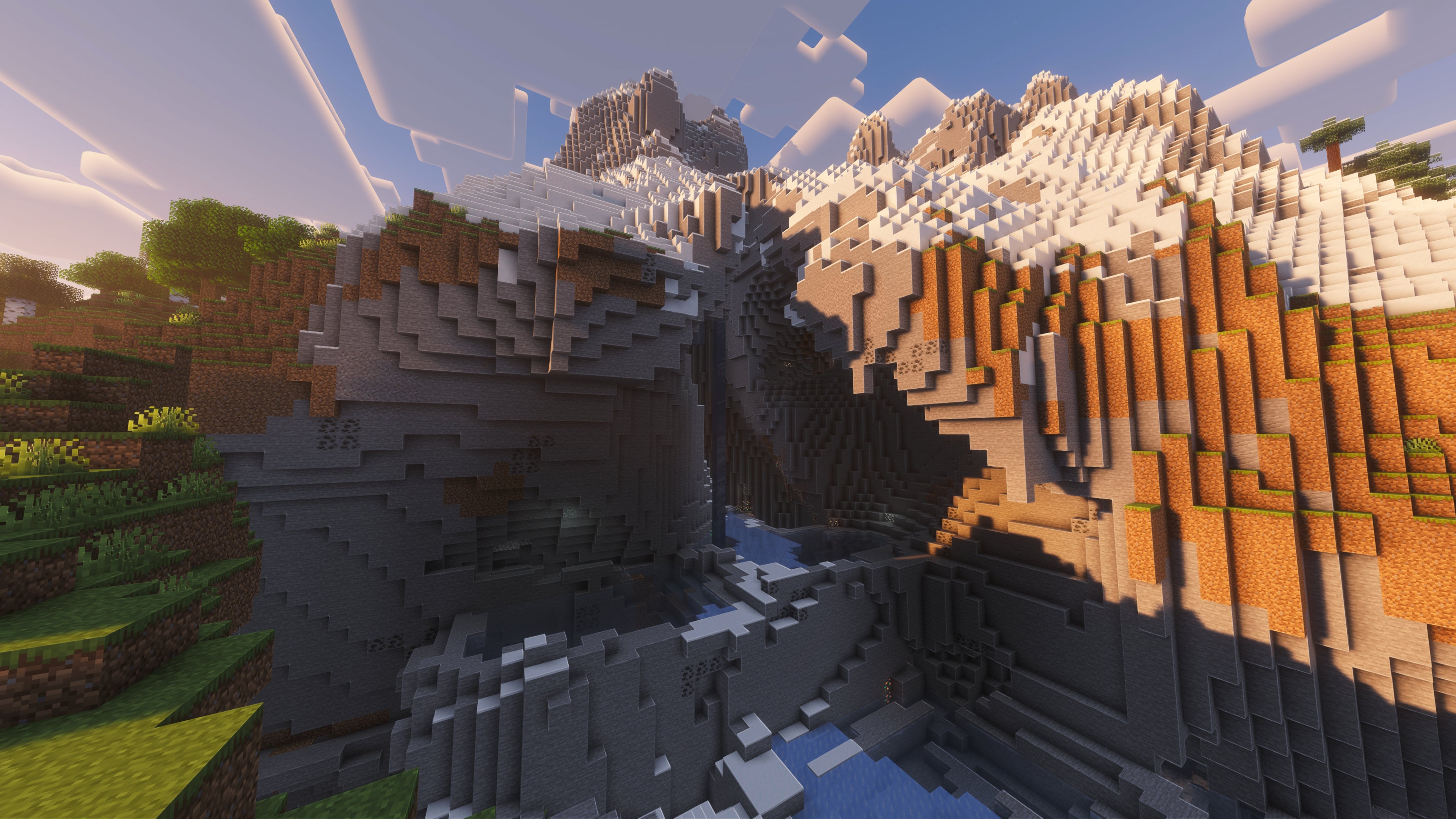 A landscape screenshot of a Minecraft seed, showing a large surface cave system built into the side of a large snow-topped mountain. - 50