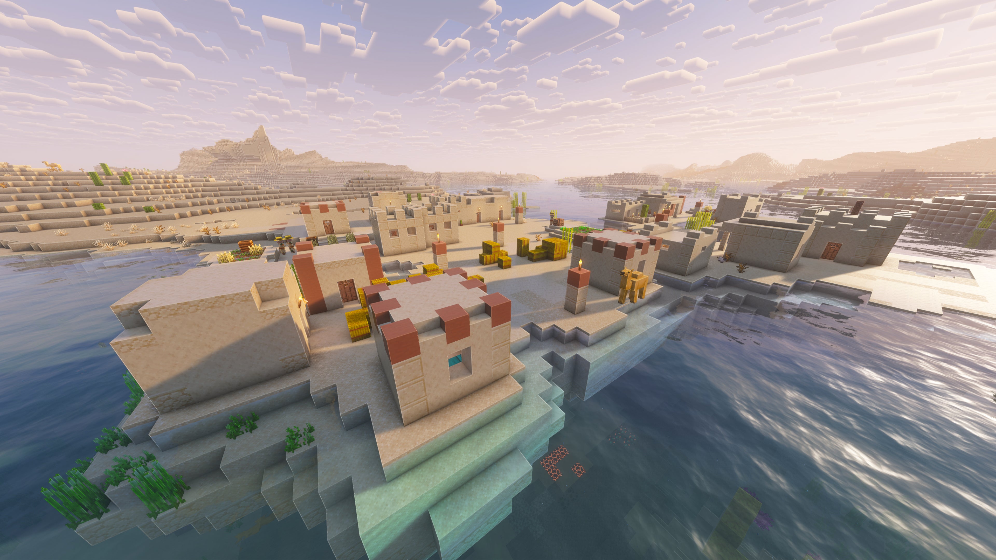 A landscape screenshot of a Minecraft seed, showing a Village built on the coast in an arid Desert biome. - 34