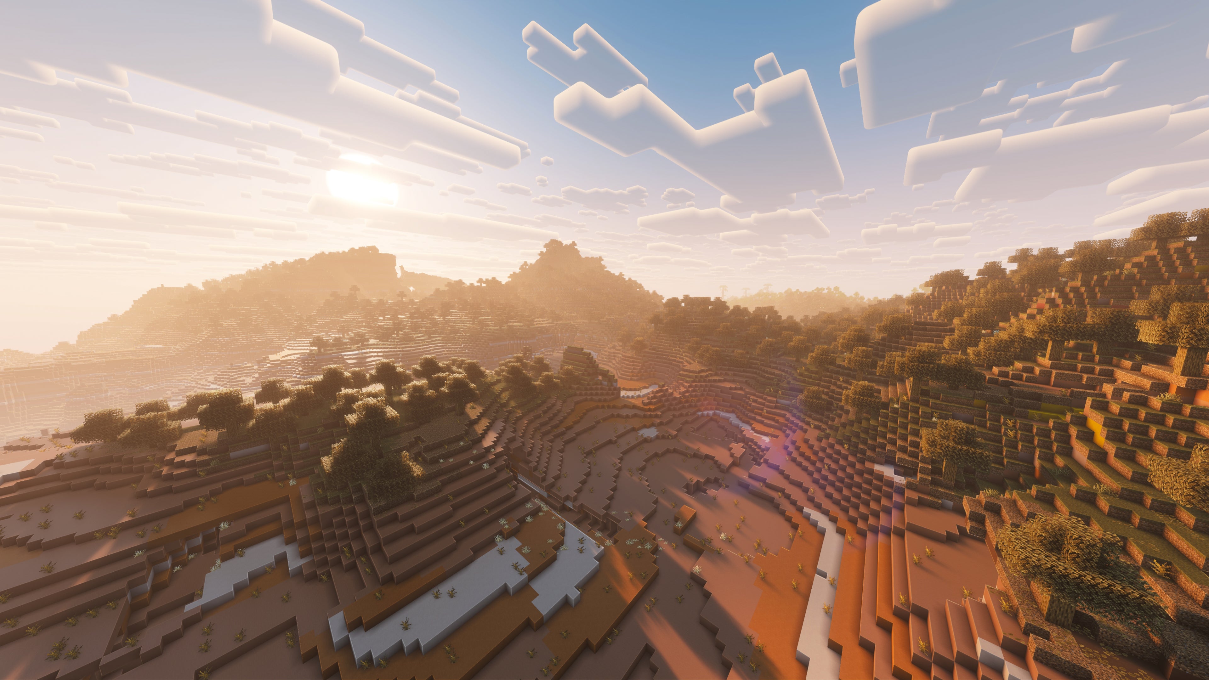 A landscape screenshot of a Minecraft seed, showing a beautiful Badlands biome at dawn.