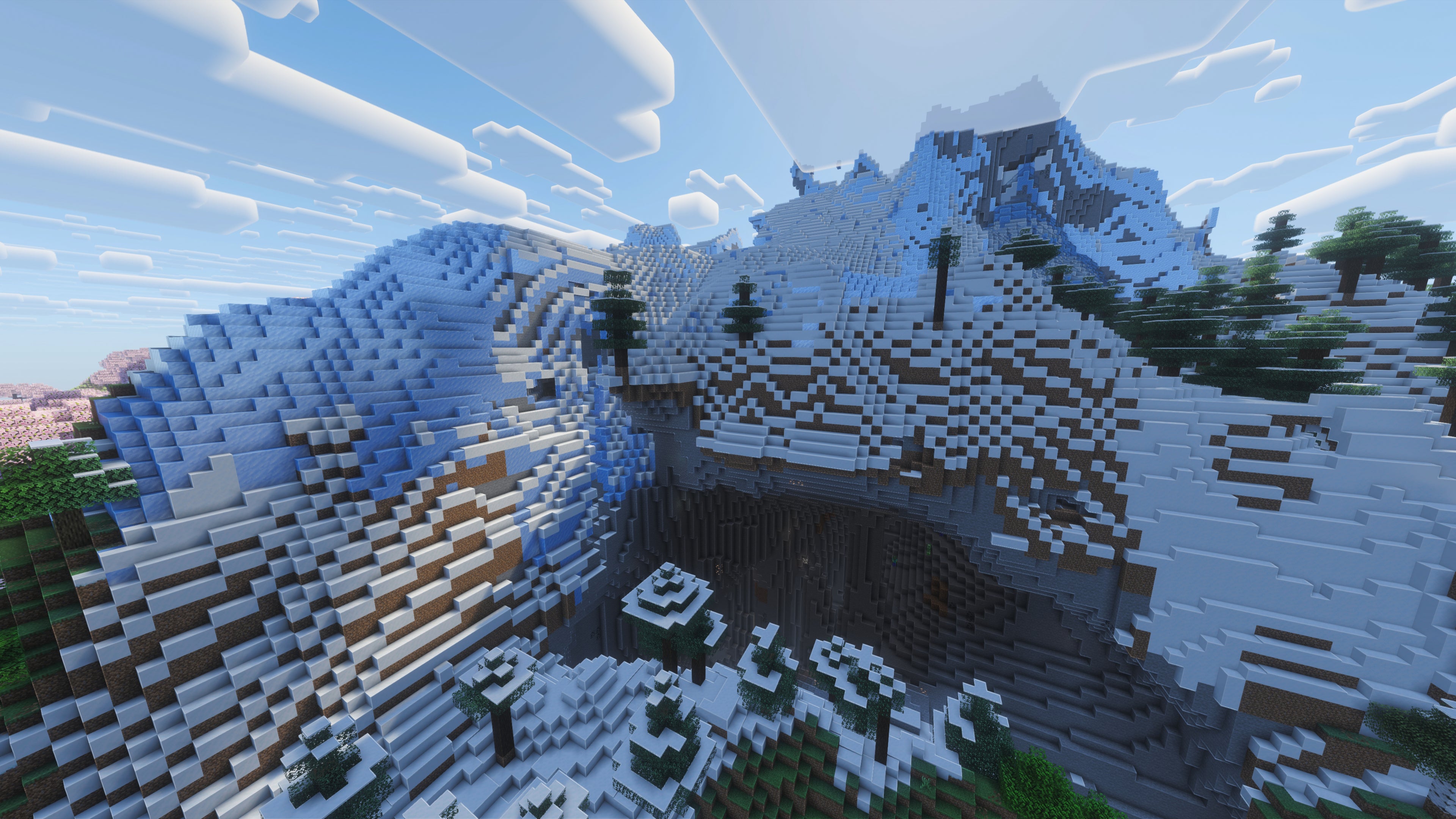 A landscape screenshot of a Minecraft seed, showing a large snow-covered hill with a massive ravine carved through its side. - 23