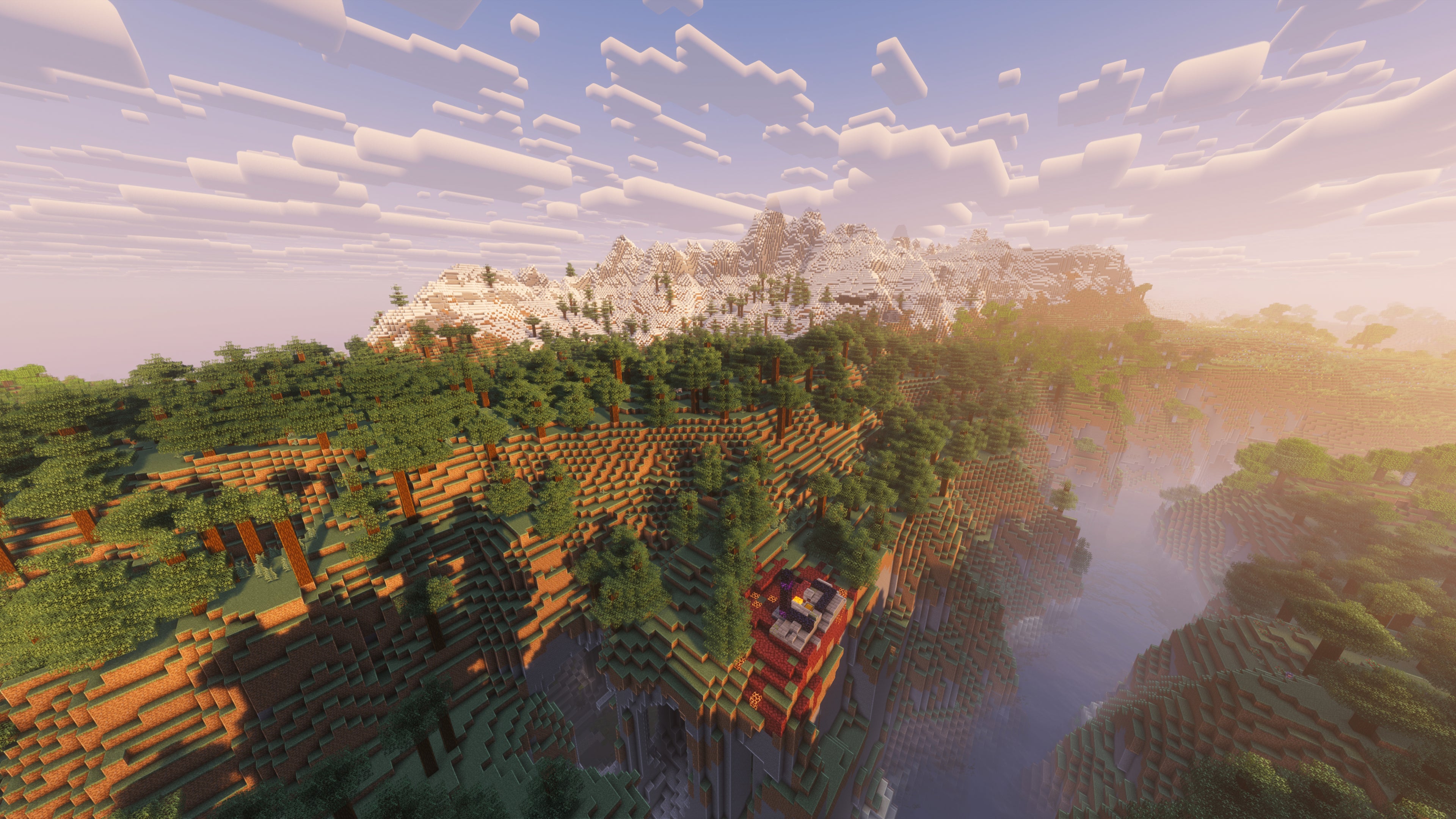 A landscape screenshot of a Minecraft seed, showing a Ruined Portal on the edge of a hill, and a large mountain range in the distance behind a forest. - 28