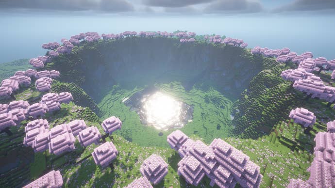 Minecraft screenshot of the ‘cherry valley’ seed showing a valley surrounded by cherry blossom trees.