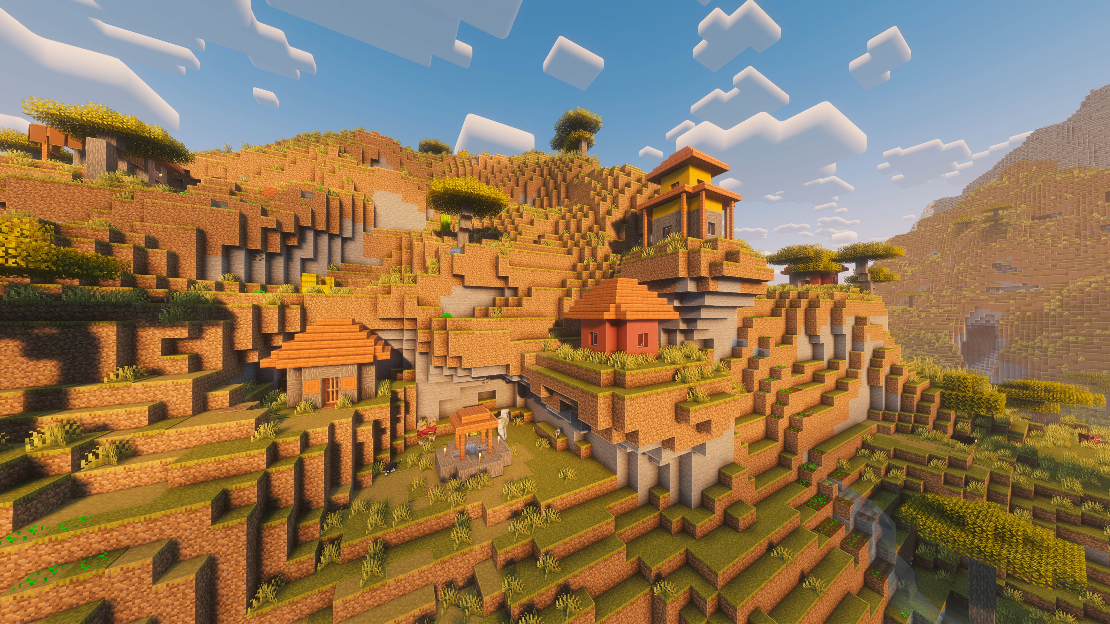 A landscape screenshot of a Minecraft seed, showing a Village built on the side of a Badlands hill. - 33