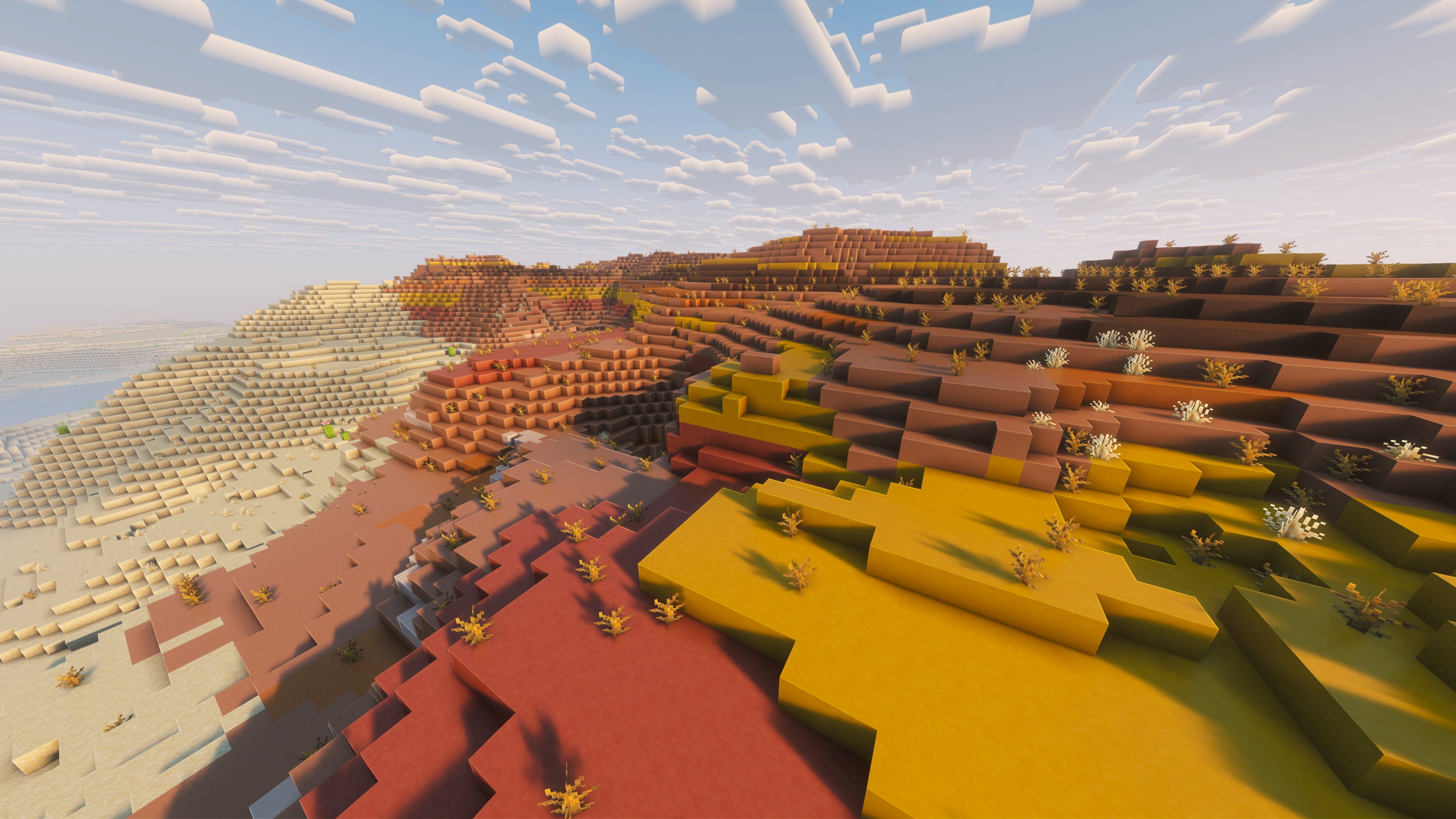 A landscape screenshot of a Minecraft seed, showing a colourful and hilly Mesa biome. - 44