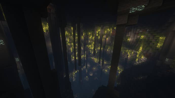 The interior of a hollow mountain in Minecraft, filled with stalactites and Lush Caves flora.