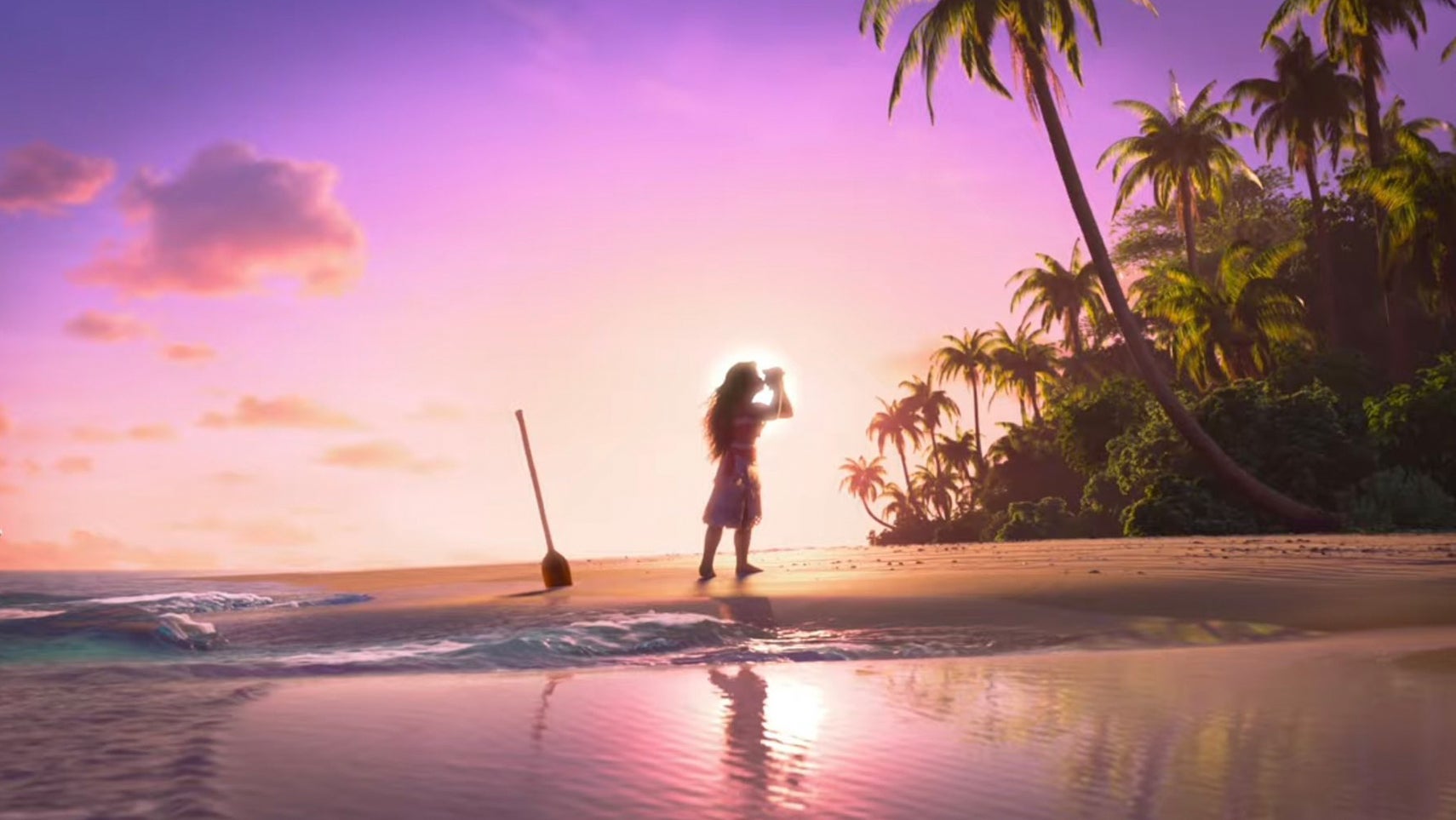 A still from Moana 2 showing Moana on a beach at sunset blowing into a shell. - 1