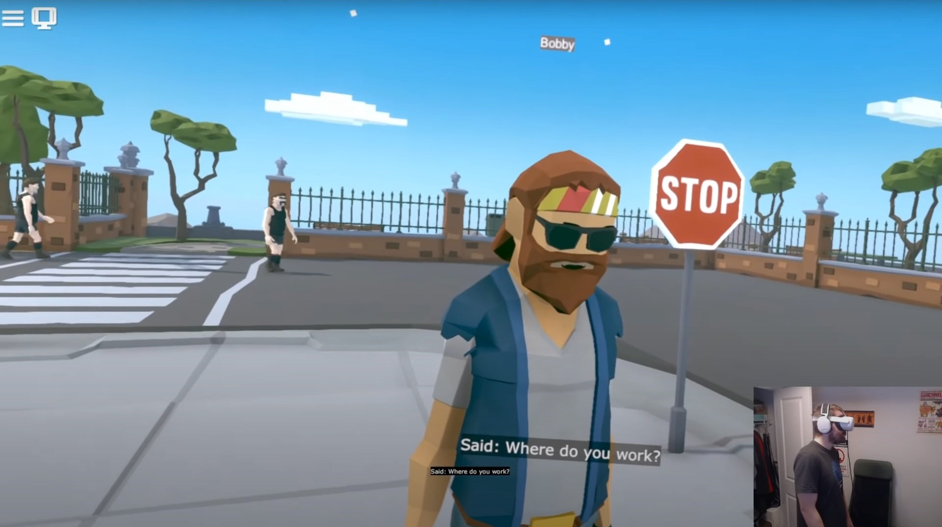 An image showing an NPC from the VR game creation sandbox Modbox. In the corner is a developer wearing VR goggles. Text at the bottom of the screen reads, &ldquo;Said: Where do you work?"