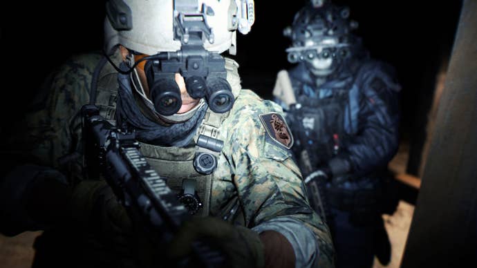 Two soldiers in Modern Warfare 2 wearing night vision goggles round a corner one after the other.
