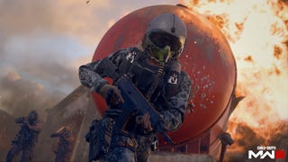 A soldier in Modern Warfare 3 stands, gun hoisted above his waist, in an action pose. Behind him, flames and a dusty sky.