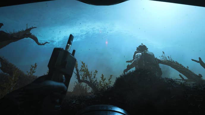 modern warfare 3 screenshot of an underwater mission intro where you hold a C4 remote in front of a rich turqoise underwater view