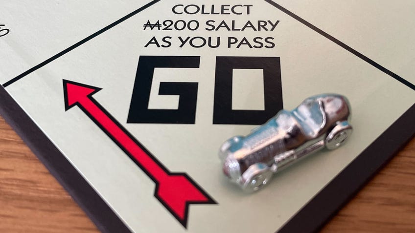 The silver race car player token on the Go square on the Monopoly board.