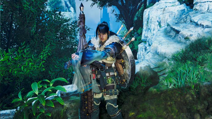 A female hunter in Monster Hunter Wilds poses in front of the camera with their weapon of choice, the Charge Blade.