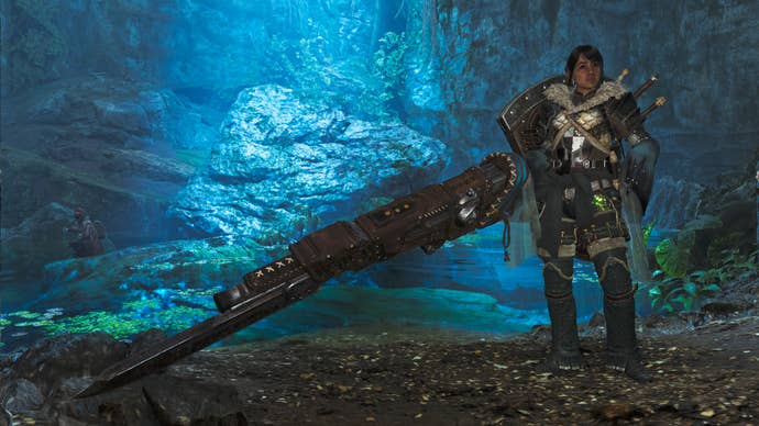 A female hunter in Monster Hunter Wilds poses in front of the camera with their weapon of choice, the Gunlance.