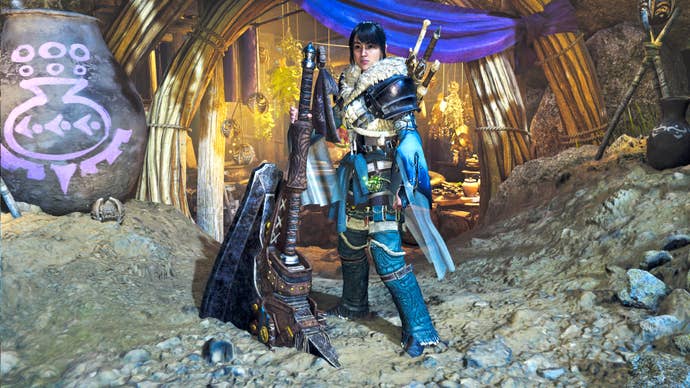 A female hunter in Monster Hunter Wilds poses in front of the camera with their weapon of choice, the Hammer.