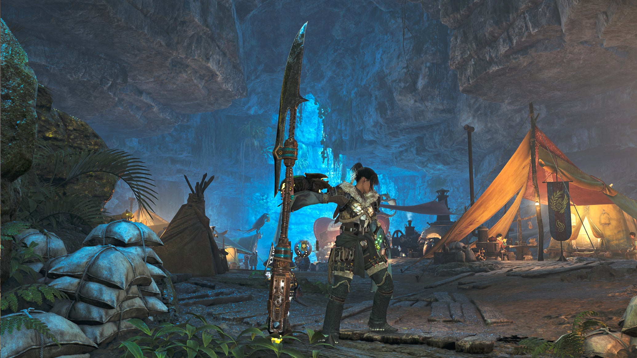 A female hunter in Monster Hunter Wilds poses in front of the camera with their weapon of choice, the Insect Glaive. - 1
