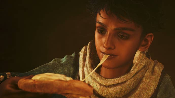 Nata, a child refugee, takes a bite of stringy cheese.