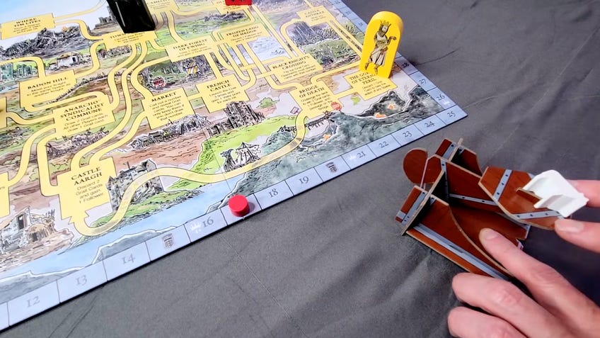 Monty Python and the Holy Grail board game backerkit video screenshot showing catapult