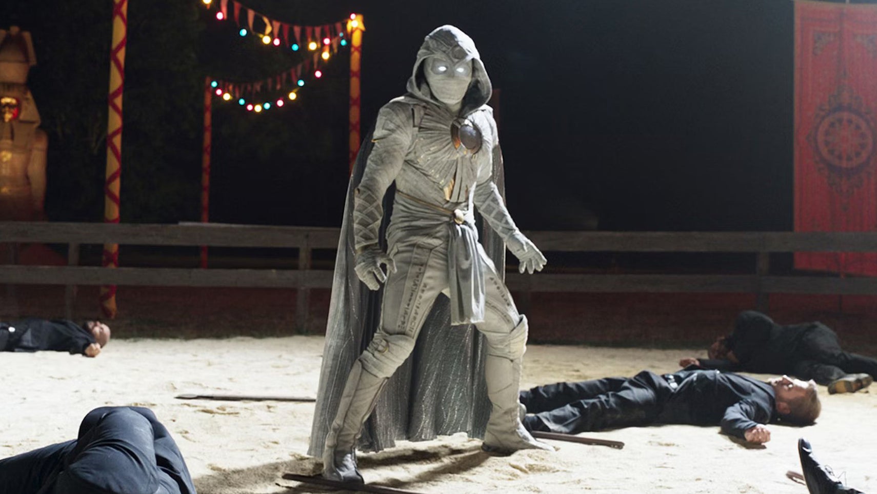 Moon Knight is stood in a carnival pen, multiple people lying unconscious/ dead on the ground. - 1