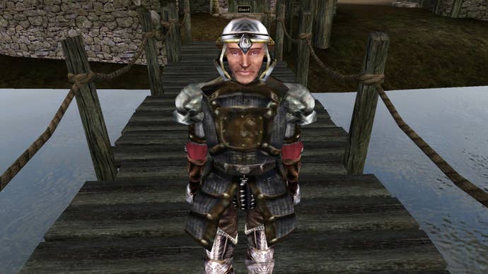 A soldier in an open-faced silver helmet stands on a wooden bridge looking at the camera.