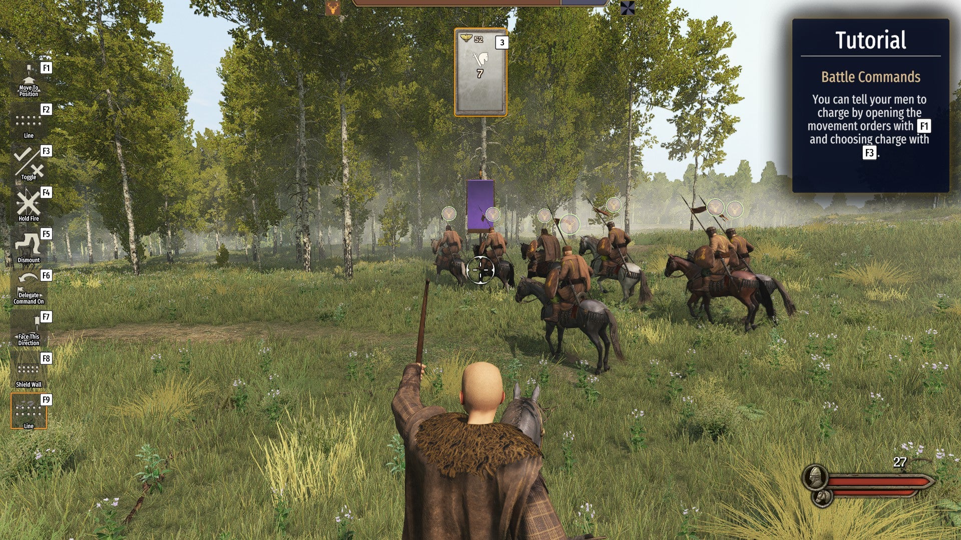 A commander on a horse, giving orders to a squadron of riders in a forest ahead of them.