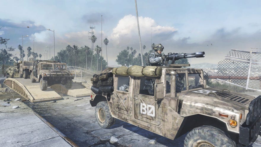 A gun mounted on a van trundles across a bridge through a war torn Modern Warfare 2 landscape.