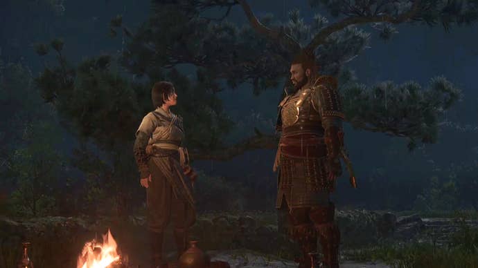Naoe and Yasuke face each other by a campfire in Assassin’s Creed Shadows.
