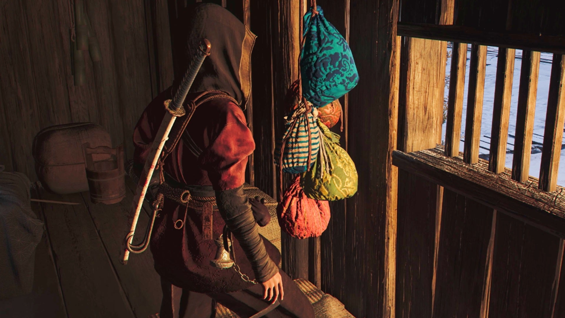 Naoe stands before a group of colourful bags that represent scouts in Assassin's Creed Shadows. - 1