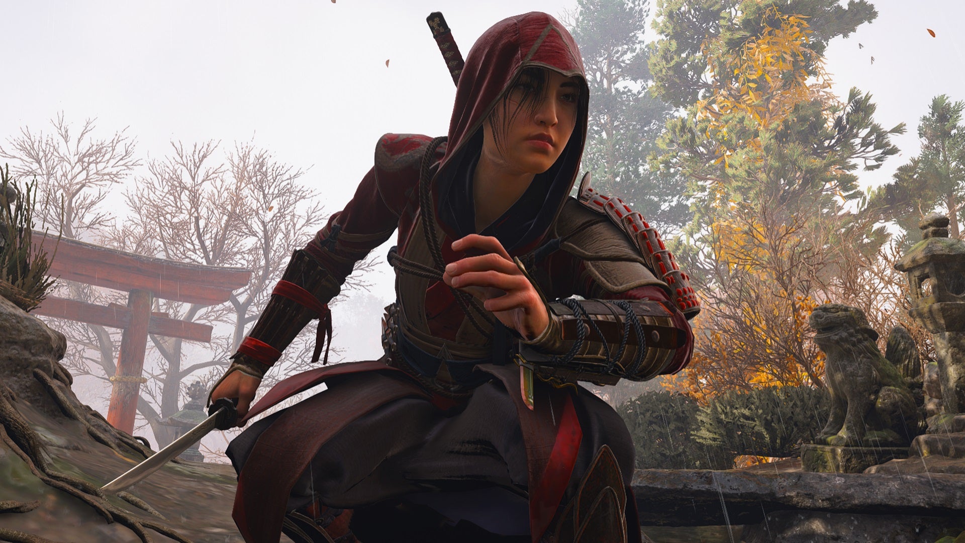 Naoe crouching while wearing her red and black Master Assassin armor set in Assassin's Creed Shadows. - 1