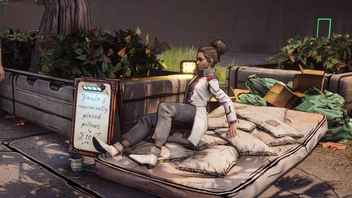 Anu from New Tales From The Borderlands has landed on a matress and pillows, next to a sign saying ‘Paula’s conveniently placed pillows’