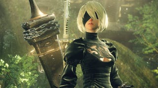 2B poses wearing a giant sword in a Nier: Automata screenshot.