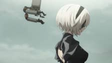A still from Nier: Automata Ver1.1a season 2 of 2B stood, the sky behind her, Pod 042 floating behind her.