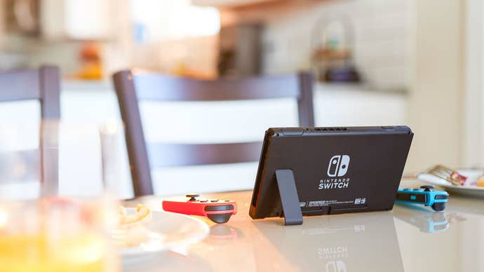 A Nintendo Switch OLED chilling on a table.