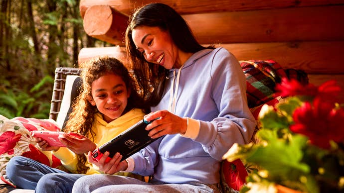 A mother and daughter playing on Nintendo Switches.